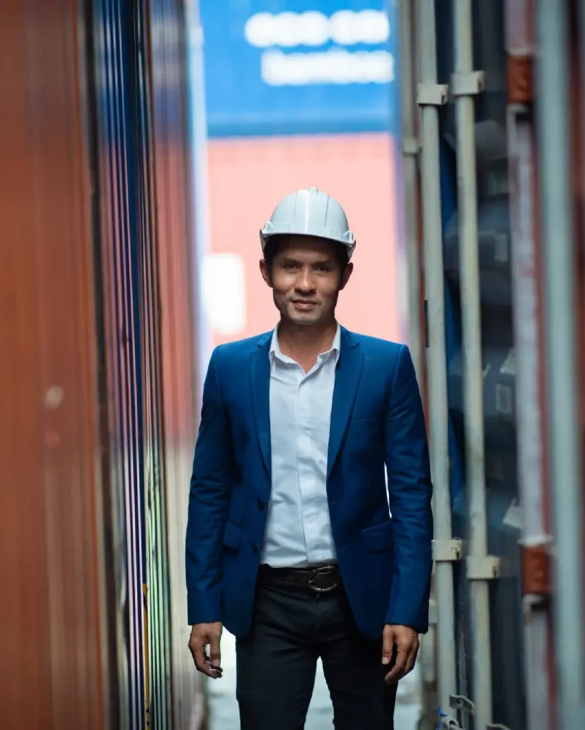 portrait of foreman worker standing at container
